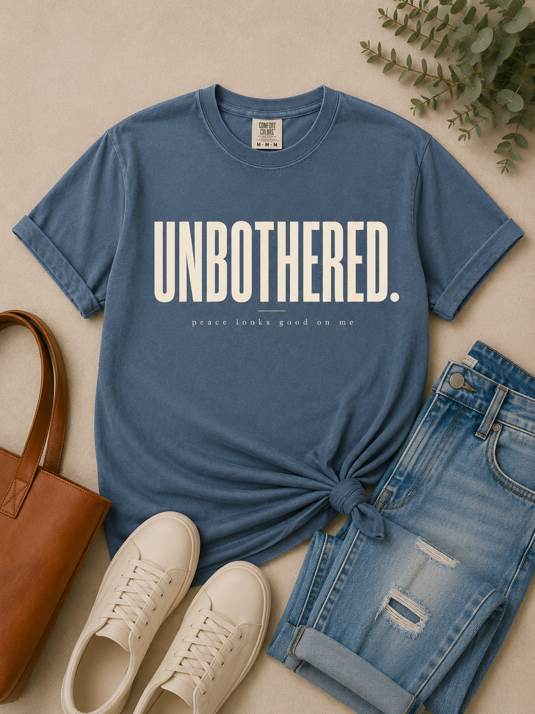 Unbothered women's statement tee in a premium lifestyle setting