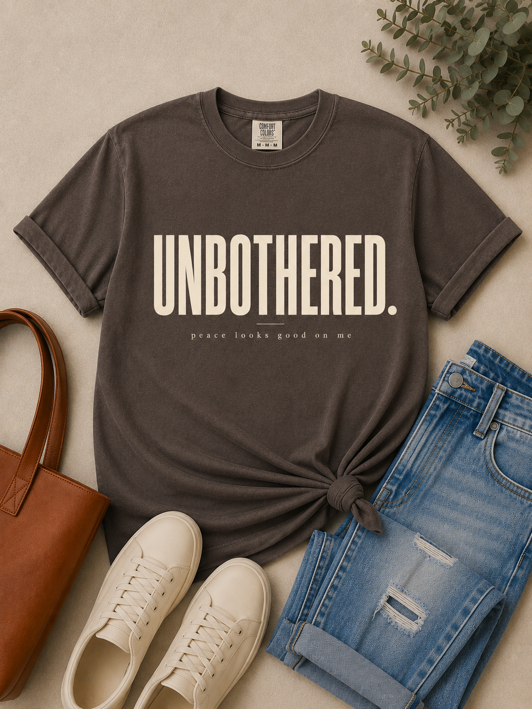 Woman styling the Unbothered graphic tee with elevated casual pieces