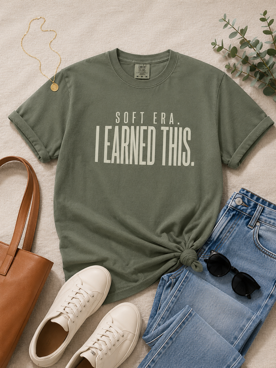 Woman wearing the Soft Era I Earned It statement tee in a relaxed lifestyle look