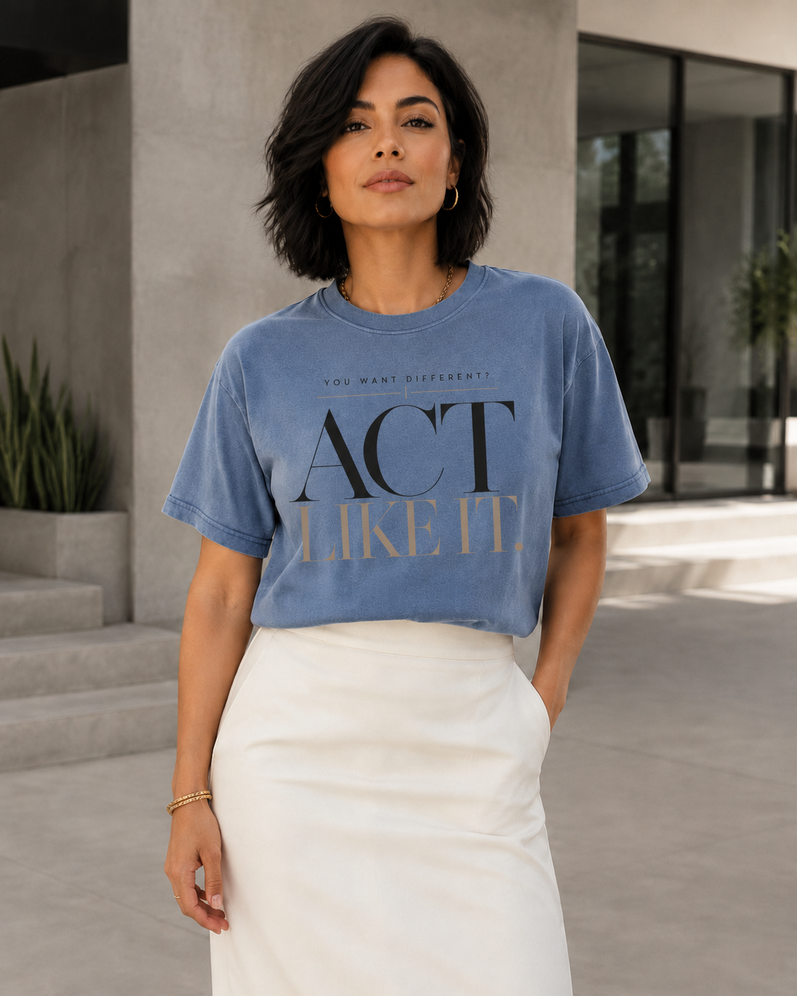 Woman wearing the Act Like It statement tee in blue jean with an ivory skirt