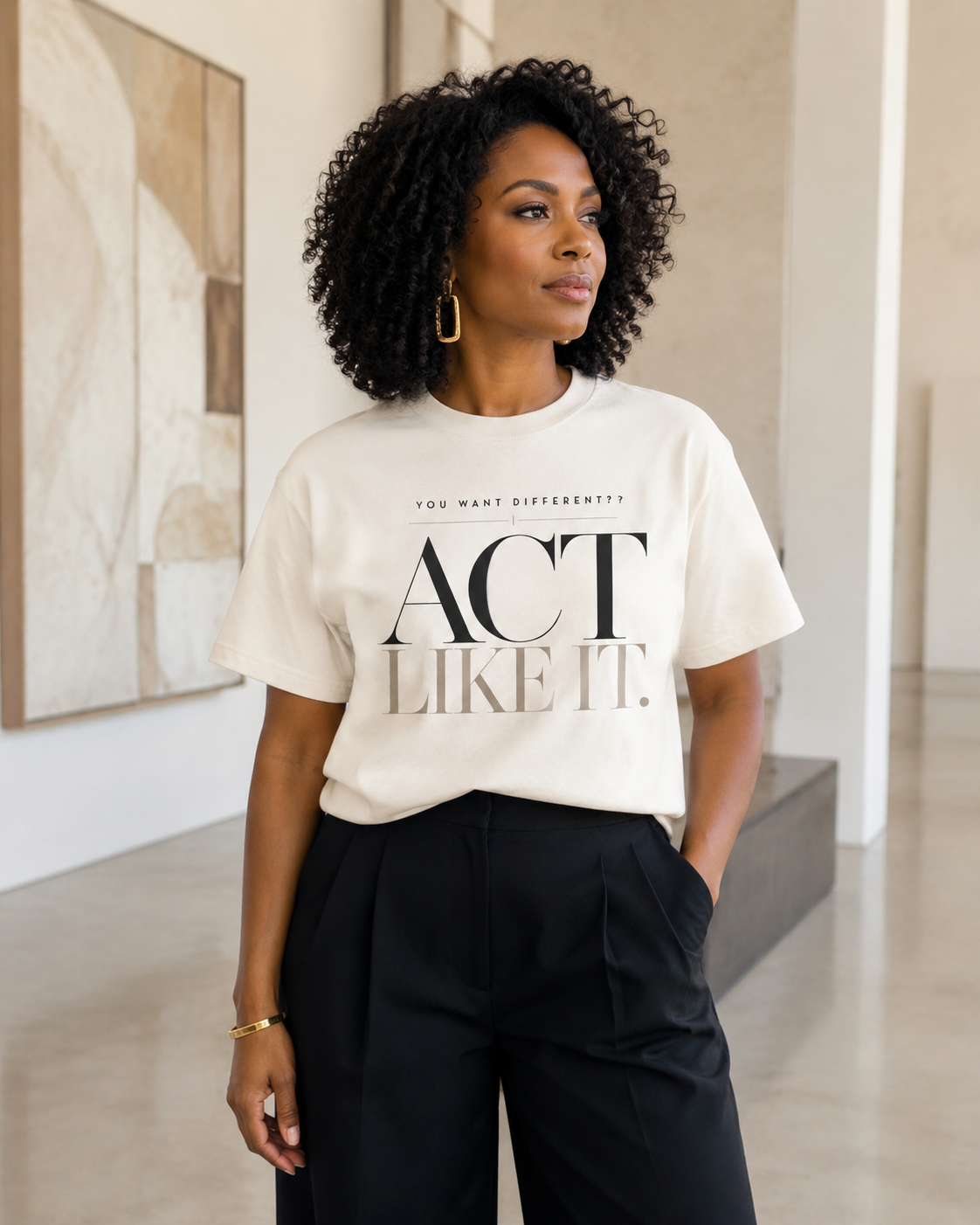 African American woman wearing the Act Like It statement tee in ivory with black tailored trousers