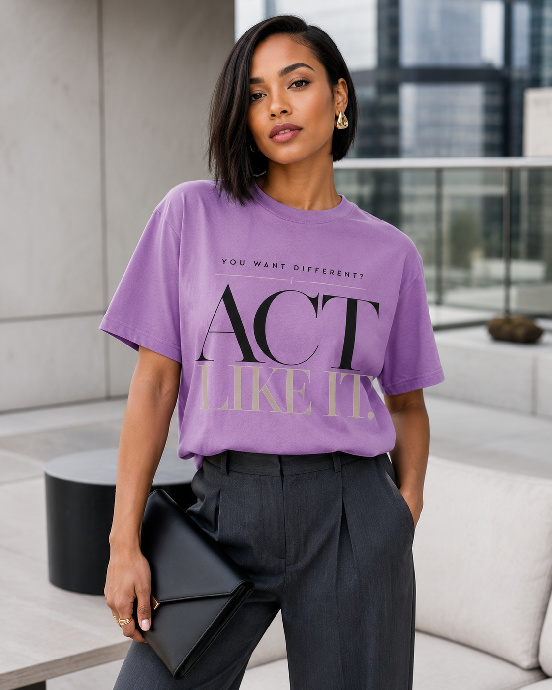 African American woman wearing the Act Like It statement tee in violet with charcoal tailored trousers