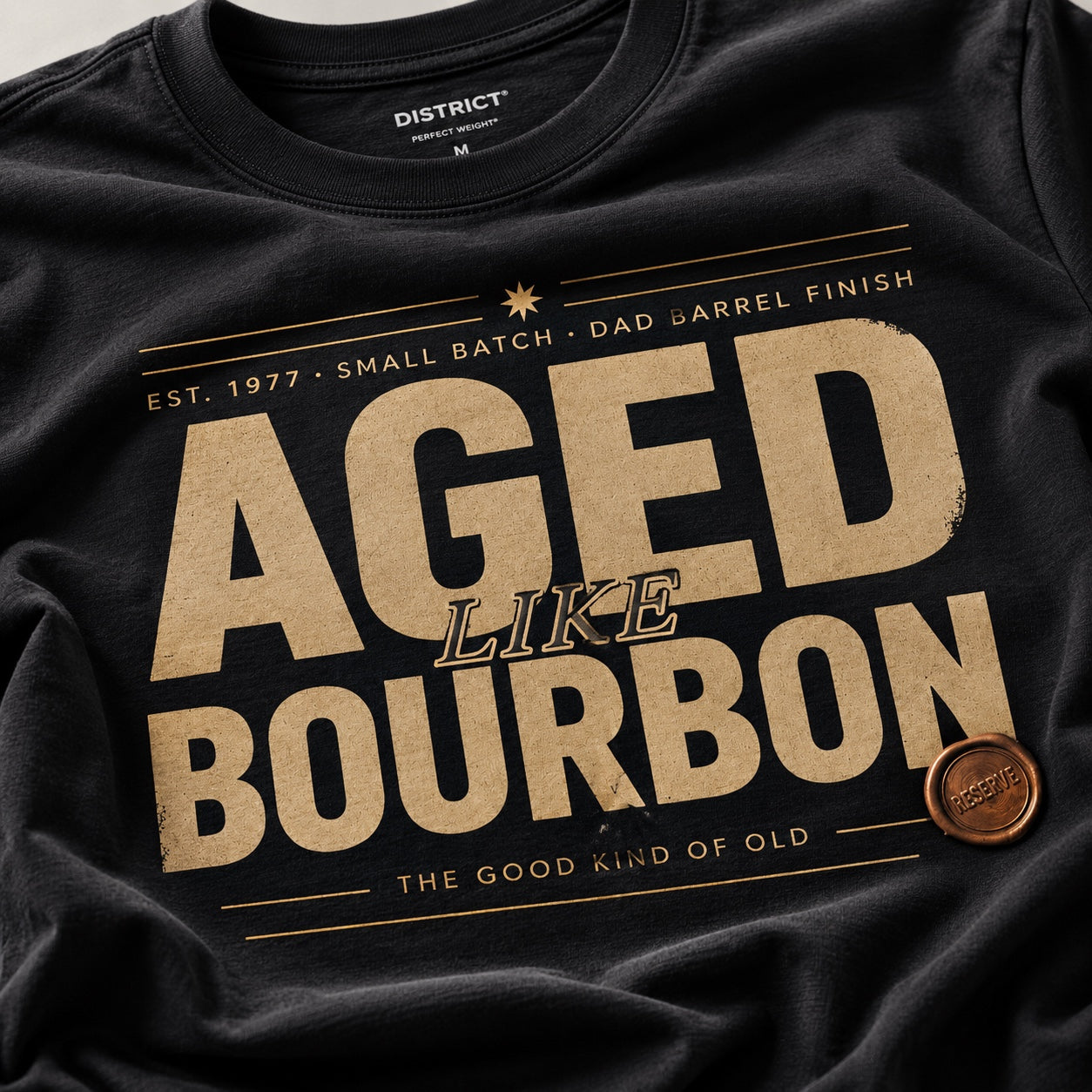 Close-up of the Aged Like Bourbon personalized design printed on a black men's tee