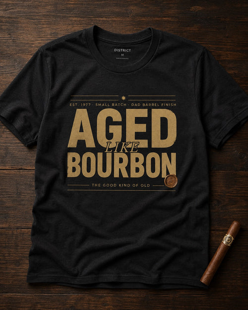 Aged Like Bourbon personalized men's black tee styled on dark wood with cigar
