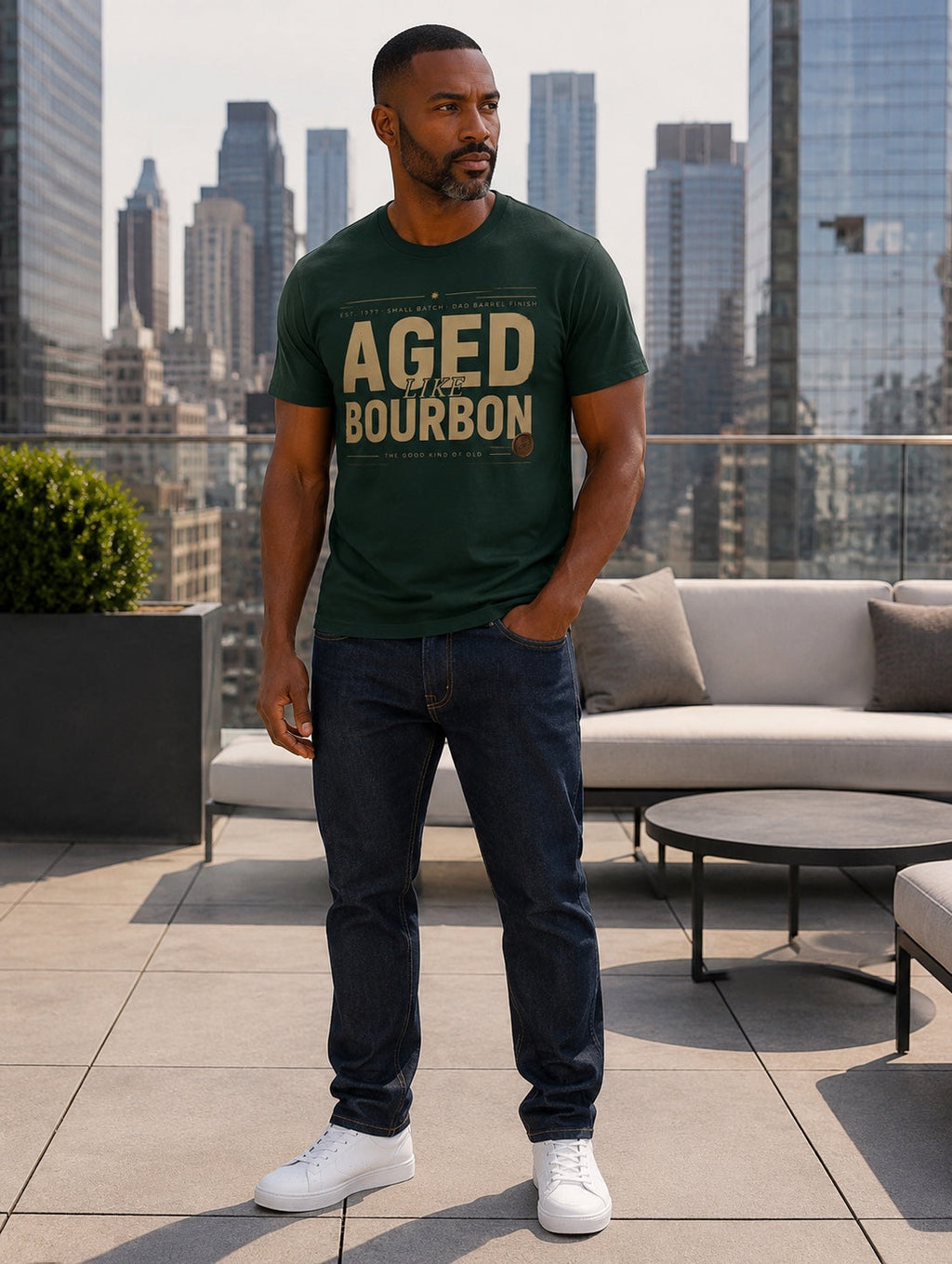 Male model wearing the personalized Aged Like Bourbon forest green tee on a city rooftop