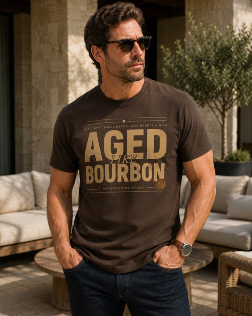 Male model wearing the Aged Like Bourbon personalized hunter brown tee