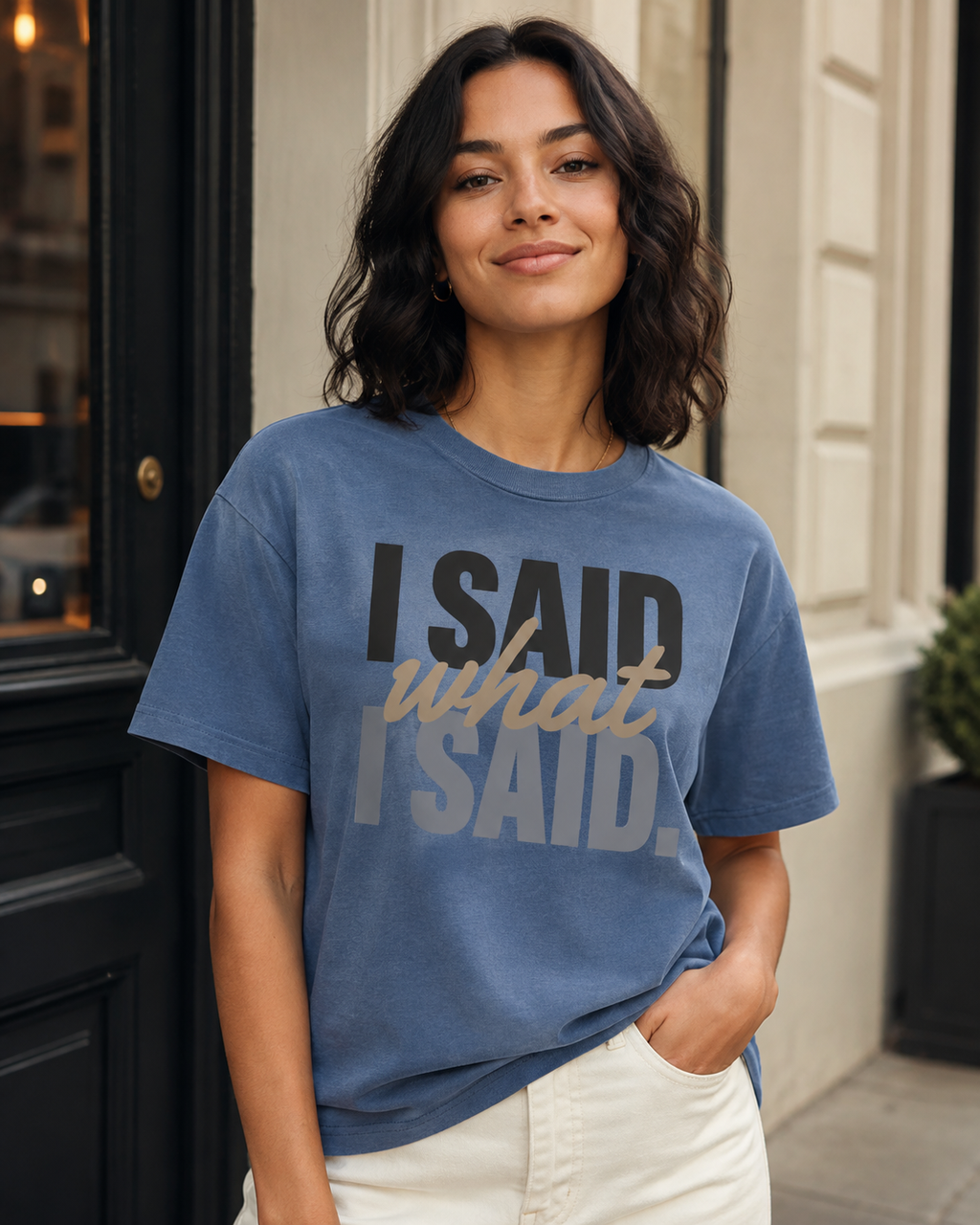 Woman wearing the I Said What I Said statement tee in Comfort Colors Blue Jean in a refined city setting.