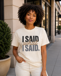 Woman wearing the I Said What I Said statement tee in Comfort Colors Ivory in an upscale outdoor setting.