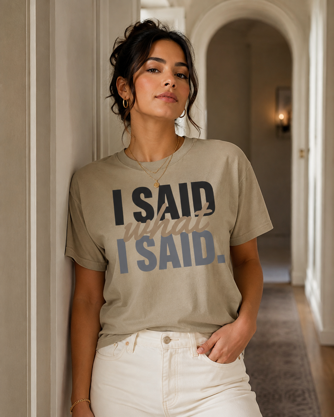 Woman wearing the I Said What I Said statement tee in Comfort Colors Khaki in a refined interior hallway.