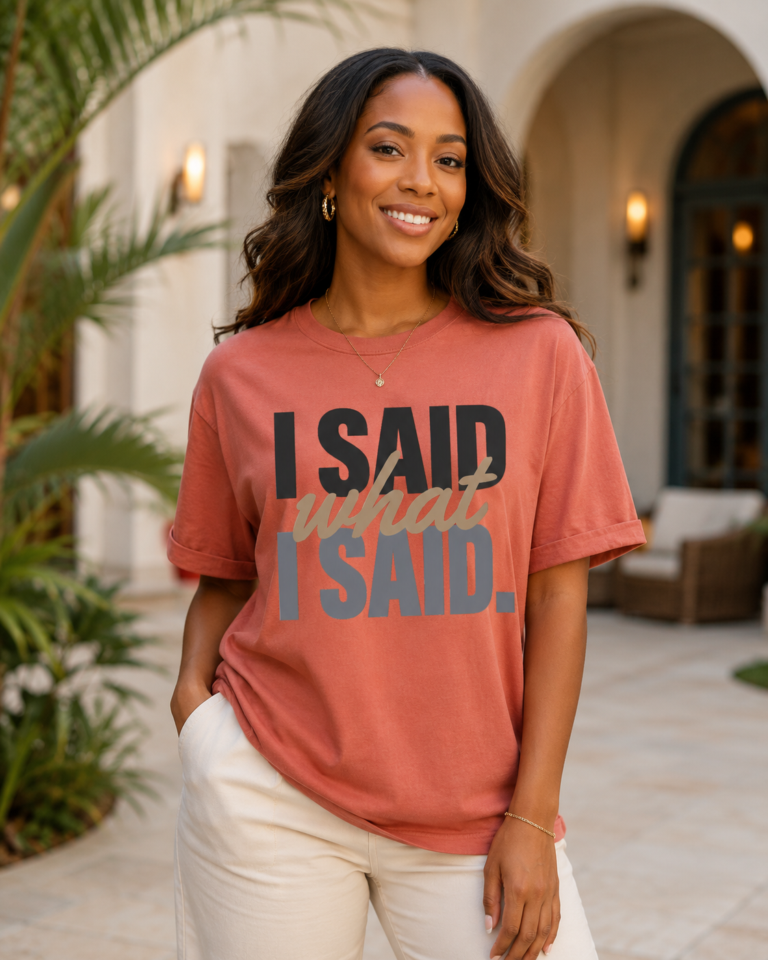 Woman wearing the I Said What I Said statement tee in Comfort Colors Terracotta in an upscale courtyard.