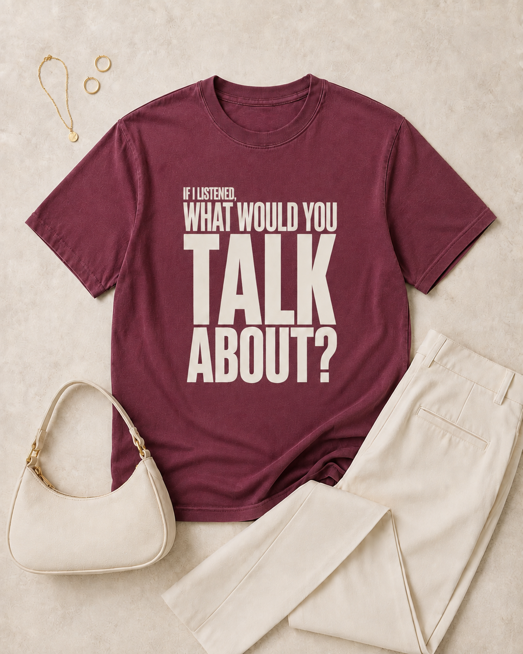 Berry statement tee flat lay with cream trousers and neutral accessories