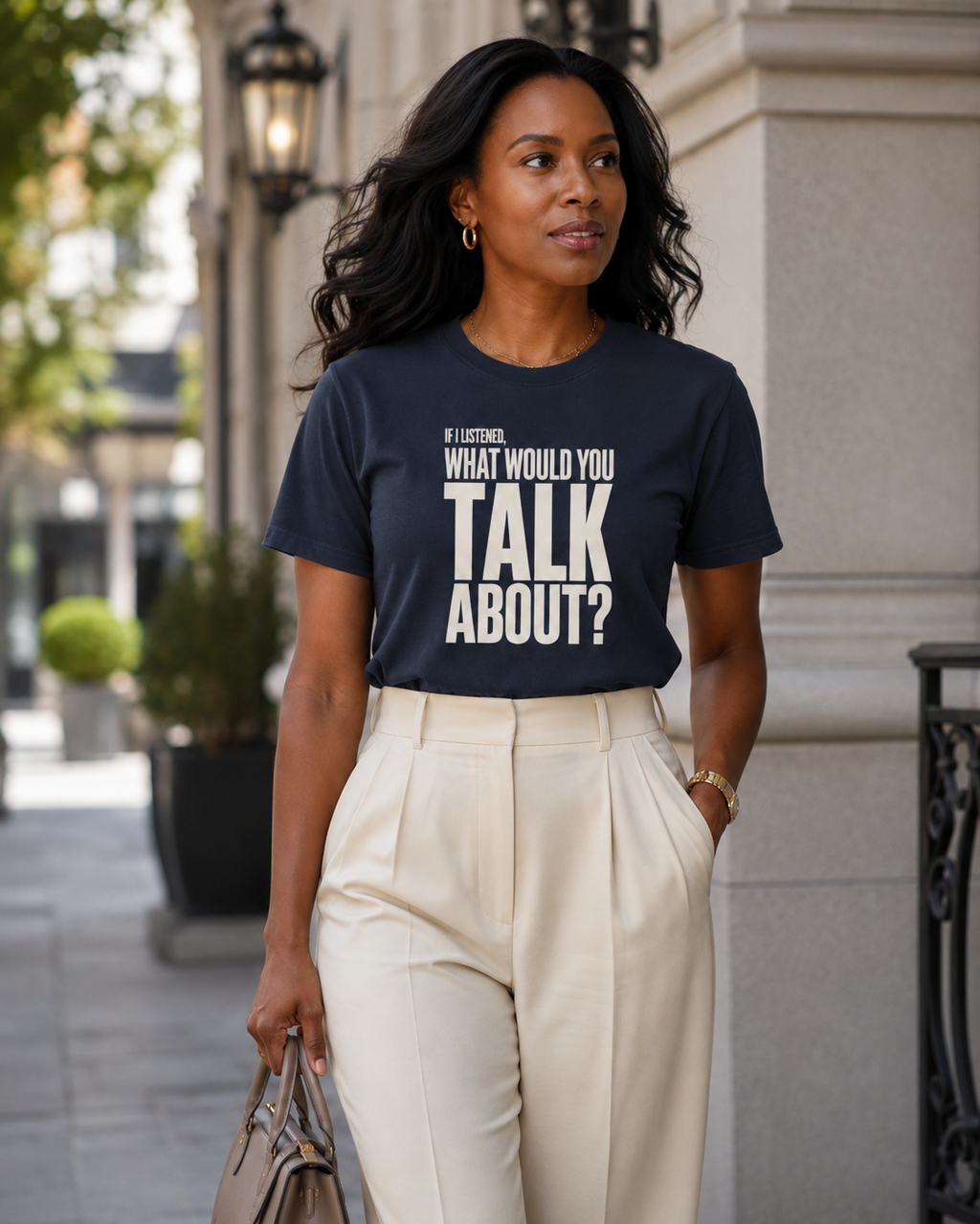 Woman wearing the If I Listened What Would You Talk About statement tee in midnight navy with cream tailored trousers