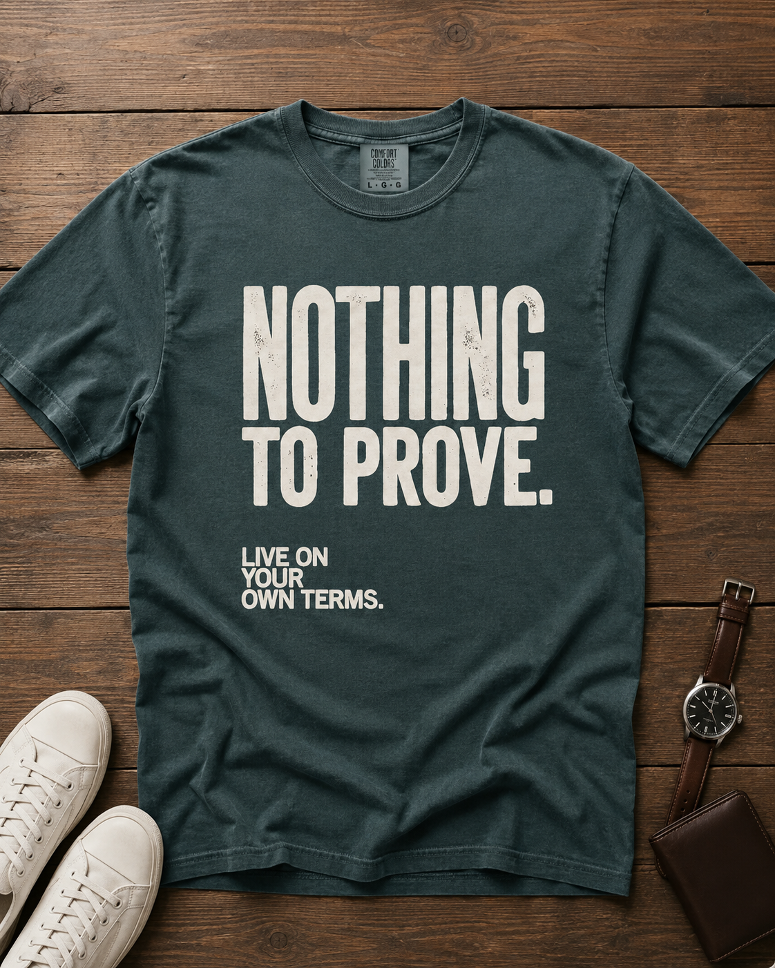 Nothing to Prove men's graphic tee in Blue Spruce, styled editorial flat lay