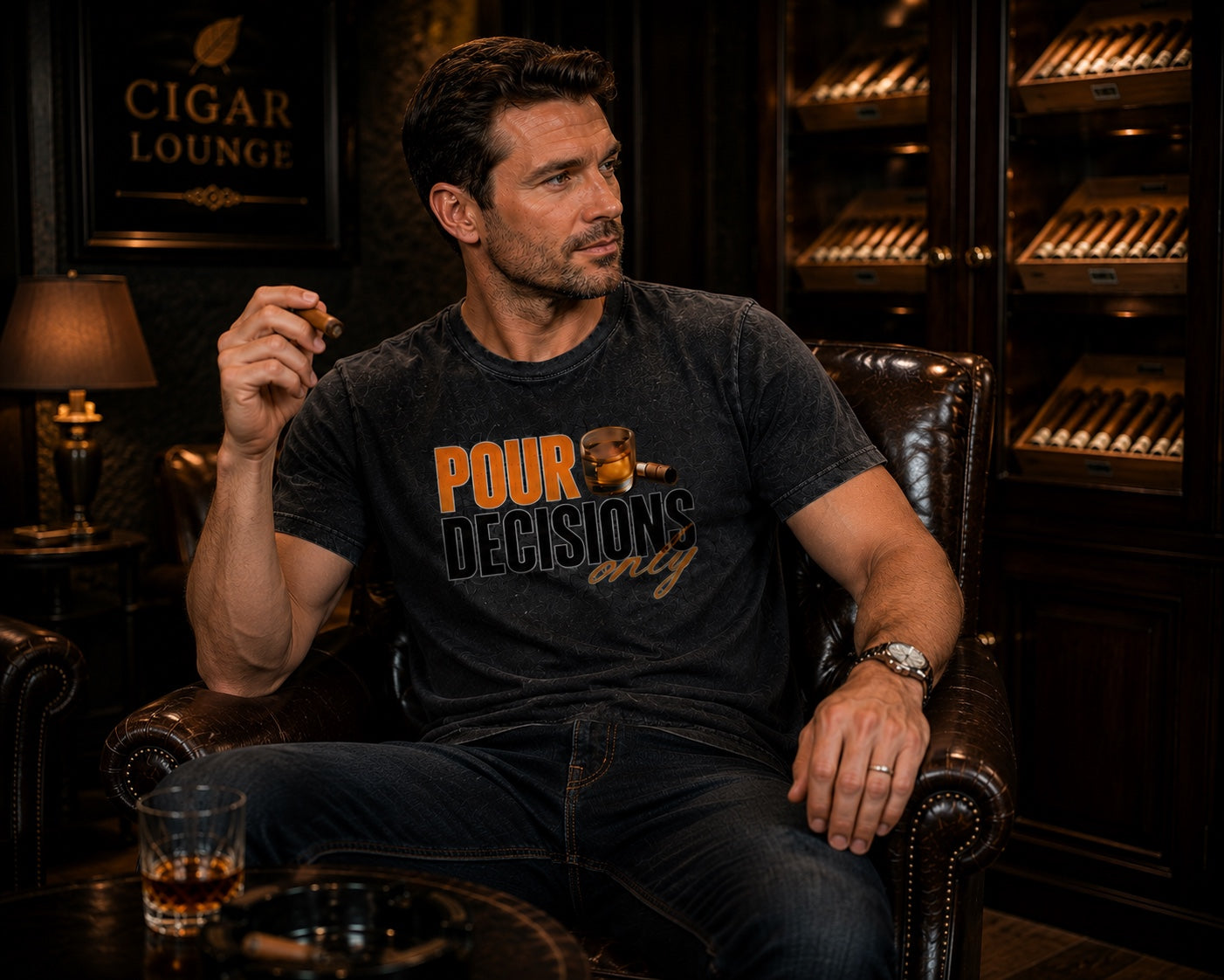 Male model wearing the Pour Decisions Only black graphic tee seated in a cigar lounge