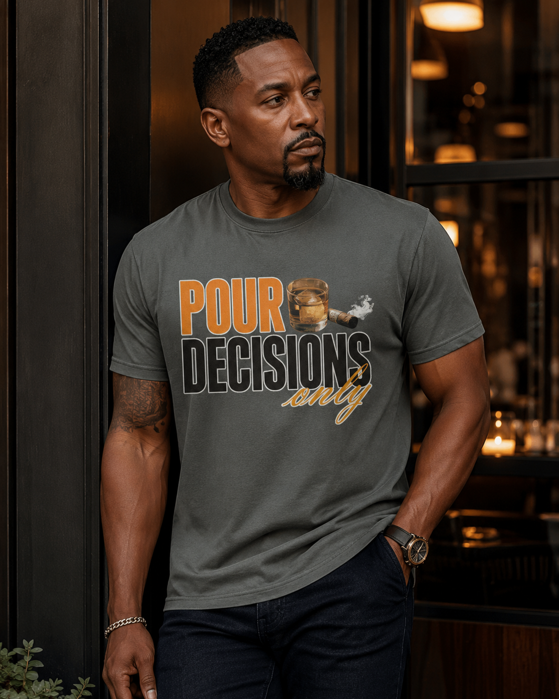 African American male model wearing the Pour Decisions Only pepper graphic tee in an upscale editorial lounge setting