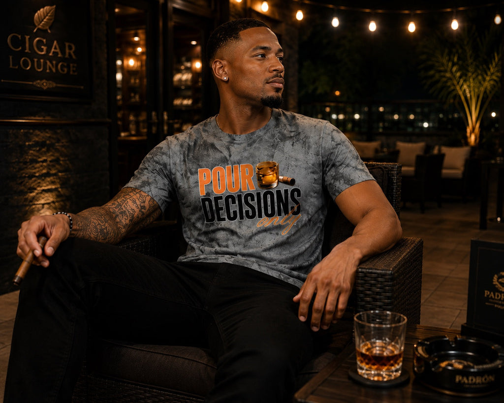 Black male model wearing the Pour Decisions Only smoke gray graphic tee in an evening cigar lounge