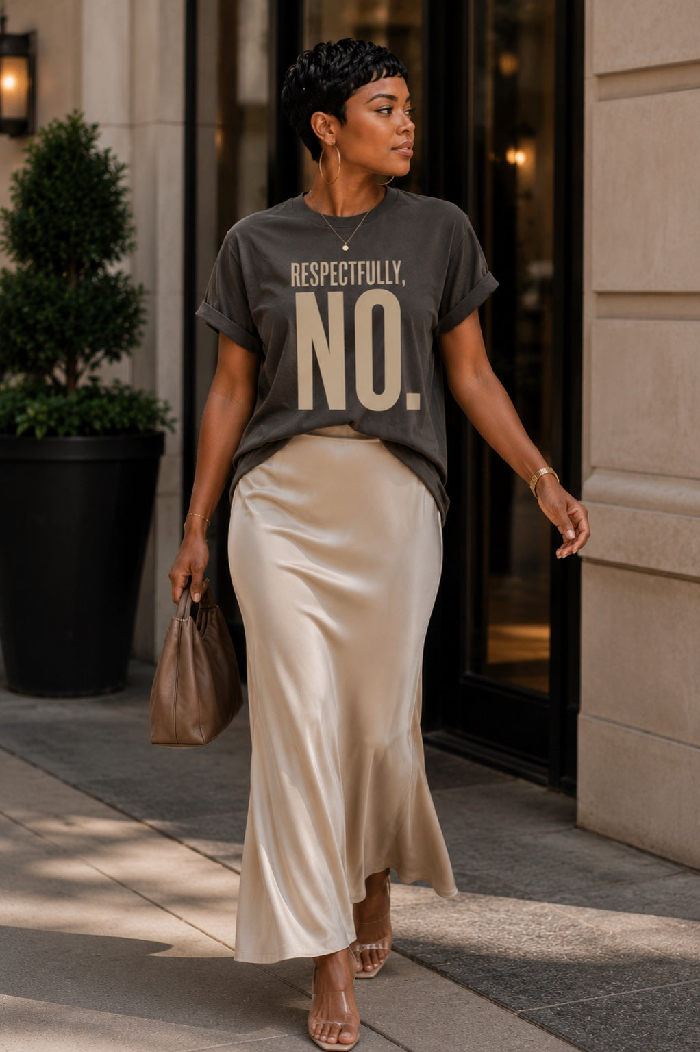 Woman wearing the Respectfully, No. tee in Comfort Colors Pepper with an ivory satin skirt.