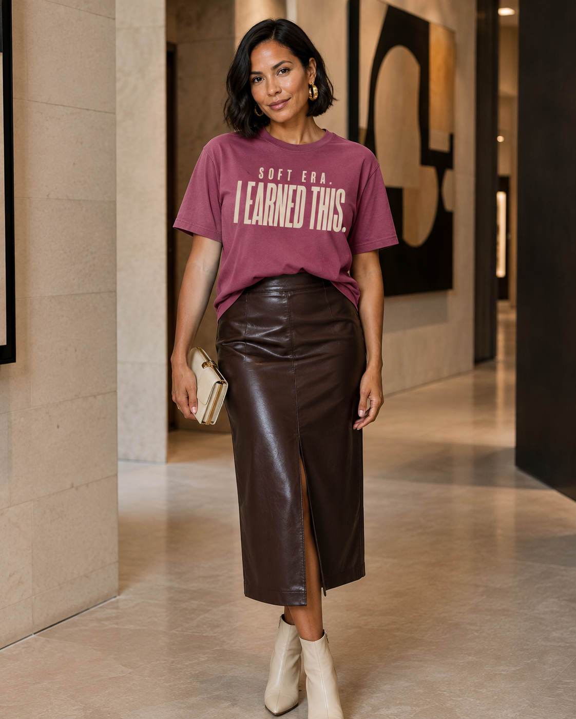 Woman wearing the Soft Era I Earned This statement tee in Comfort Colors Berry