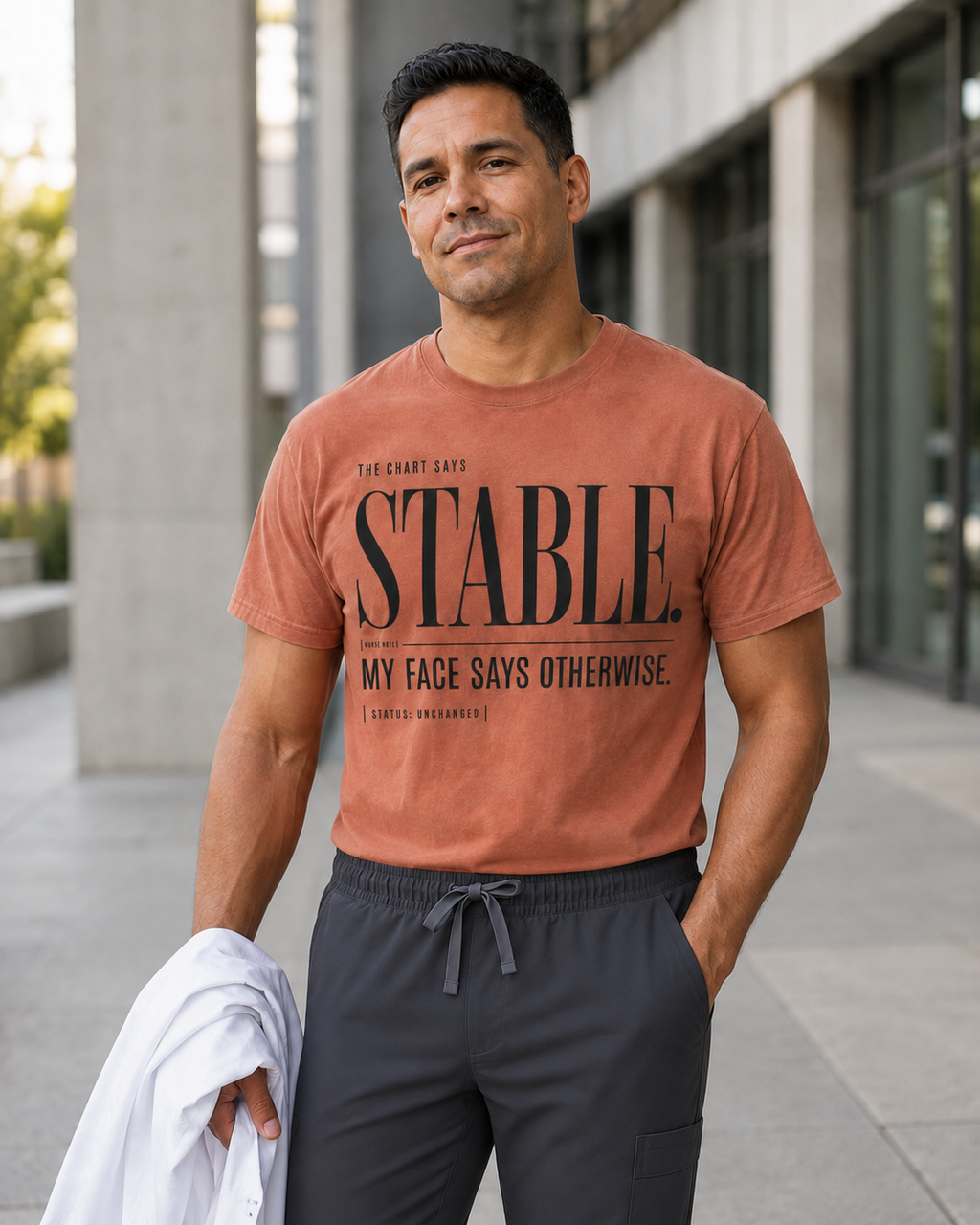 Male nurse wearing Terracotta Stable My Face Says Otherwise tee with scrub pants
