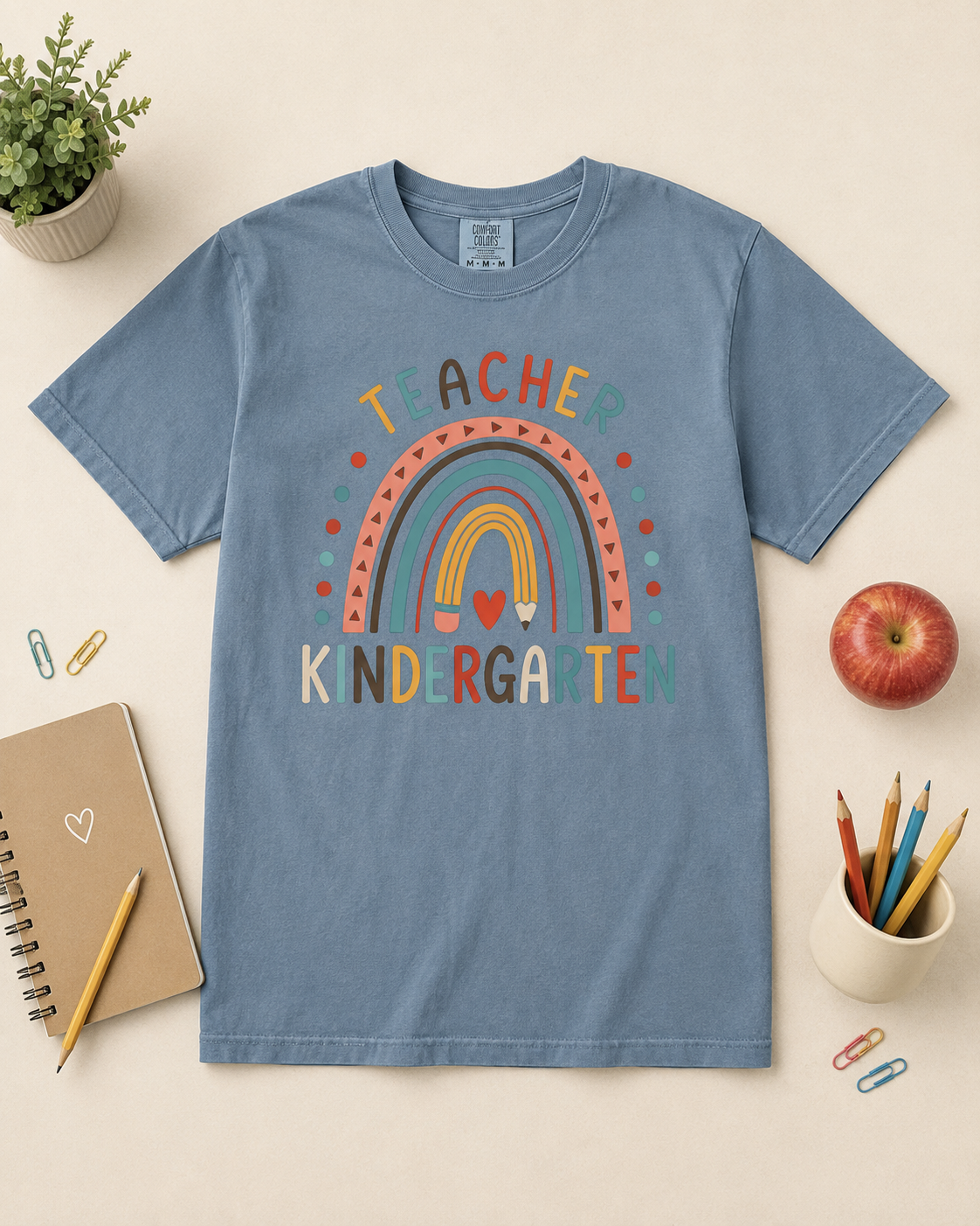 Kindergarten rainbow teacher tee Blue Jean Comfort Colors styled flat lay