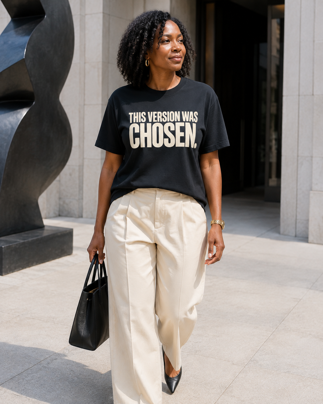 African American woman wearing the This Version Was Chosen statement tee in black with cream typography