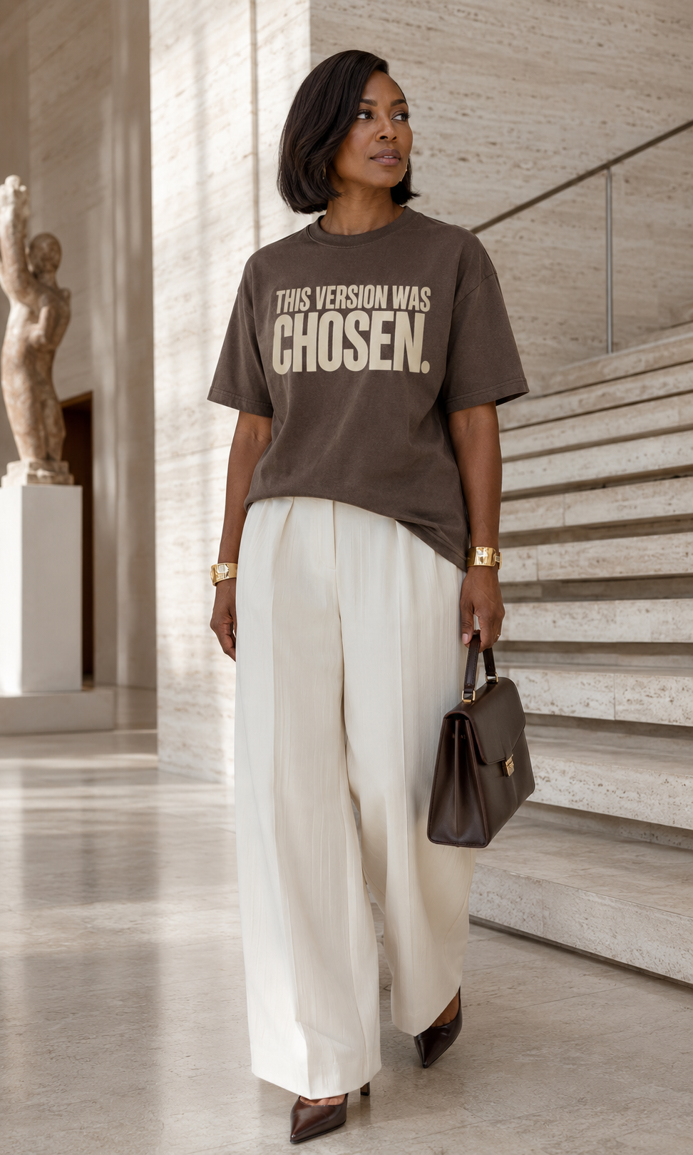 African American woman wearing the This Version Was Chosen statement tee in espresso with cream typography