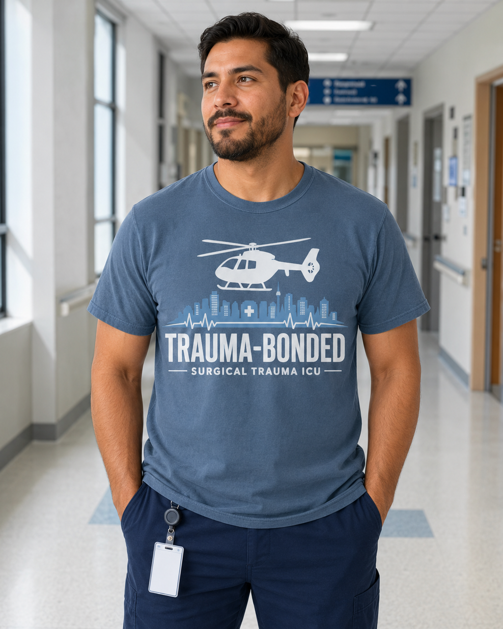 Trauma Bonded Surgical Trauma ICU tee in Comfort Colors Blue Jean on Hispanic male nurse